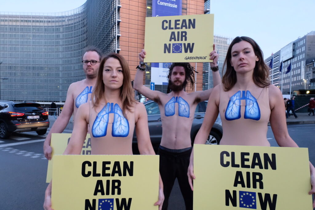 Greenpeace activists, with body-painted lungs on their chest, protest in front of the EU Commission Building against the lack of credible action against harmful air pollution in European countries.